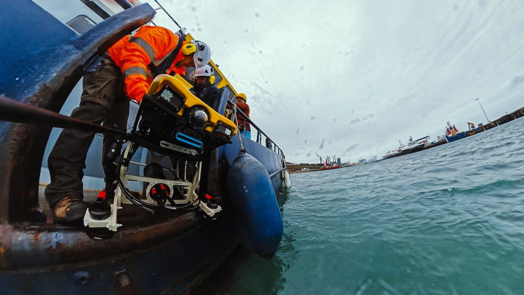 ROV being lowered over the side of a workboat during trials at Portland
