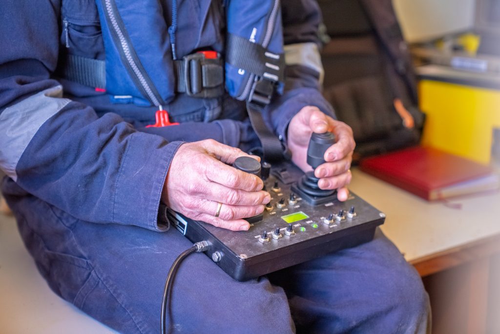 ROV pilot operating the hand controller during a dive