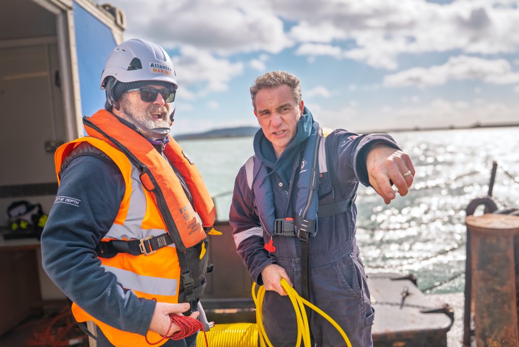 Two crew on deck of the workboat planning the next ROV deployment