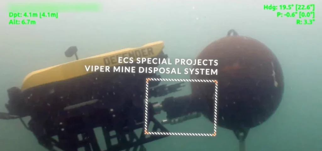 Film still with on-screen callouts showing an underwater mine disposal system