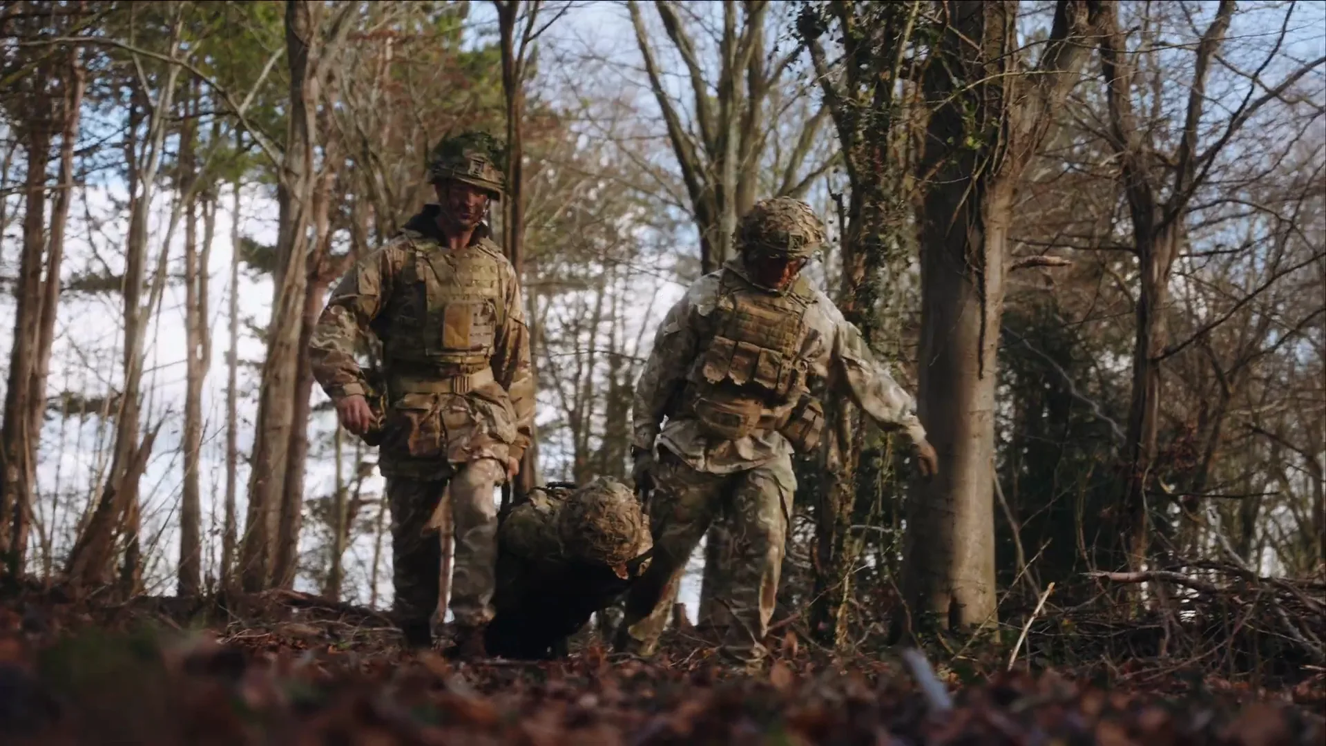 Soldiers carrying a casualty on the CQC Fibrelight folding stretcher through woodland
