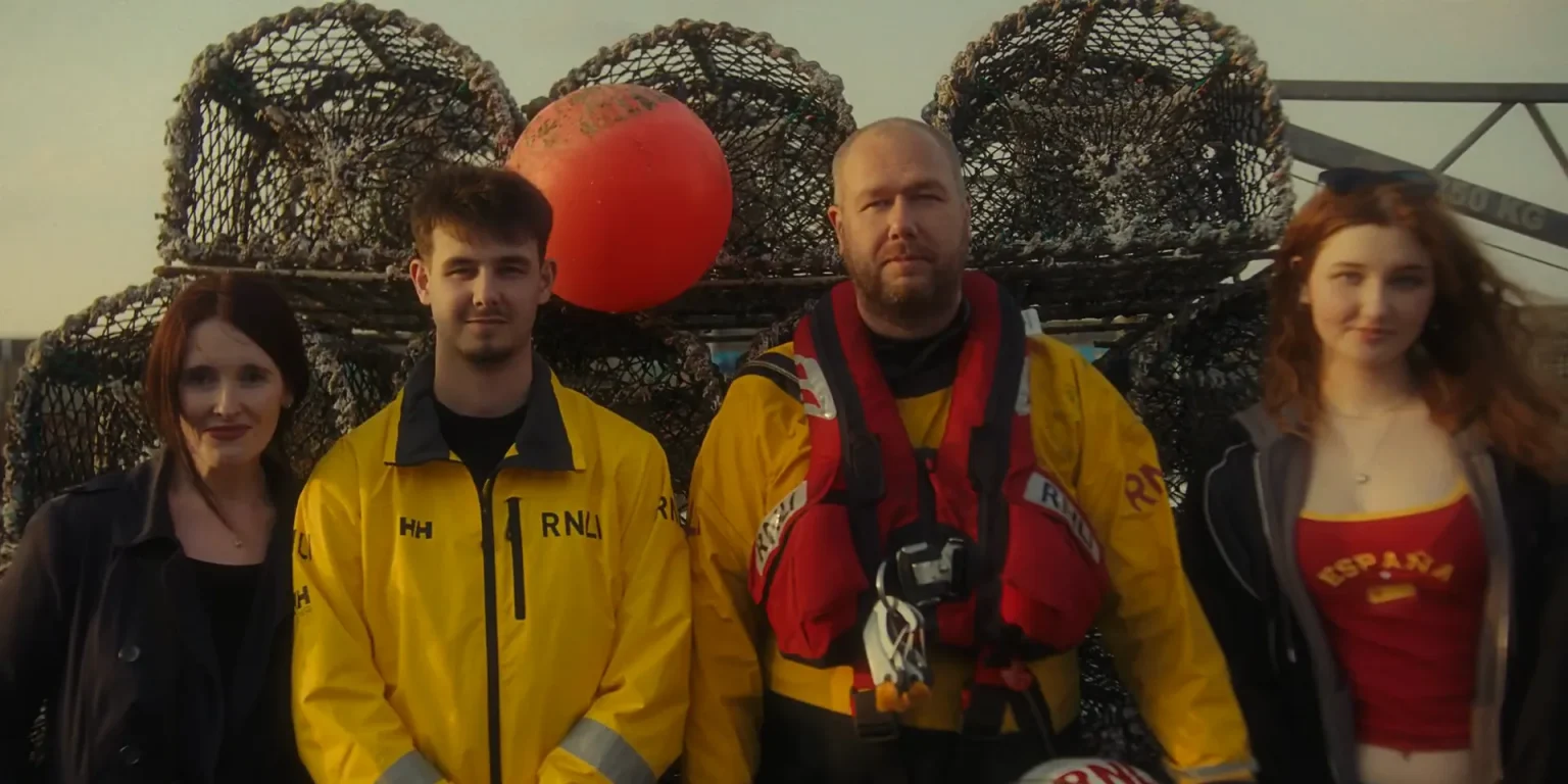 Dunbar RNLI volunteers and local people by the harbour