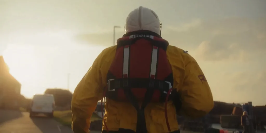 RNLI volunteer heading to the lifeboat station