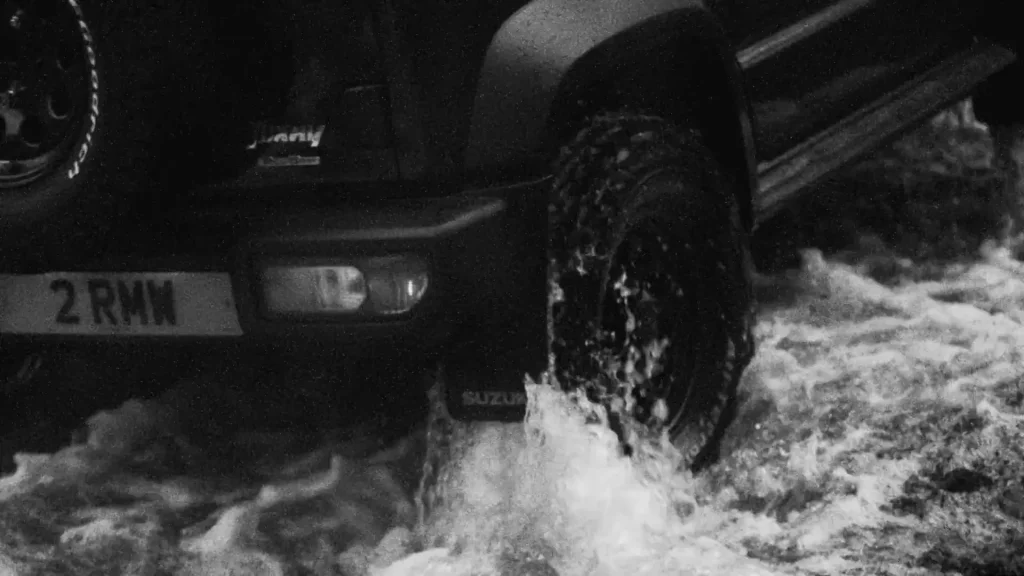 Jimny wheel splashing through a ford