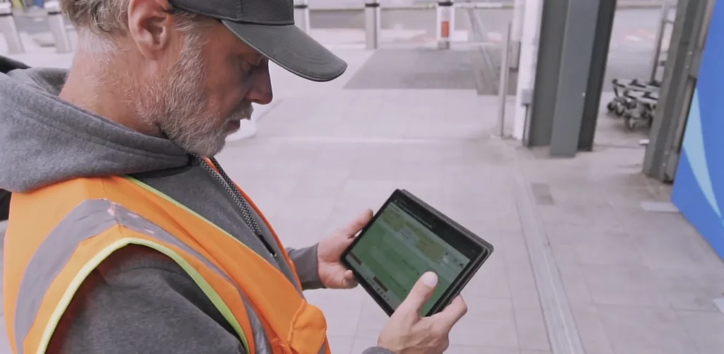 Gatwick staff member checking the asbestos register on a tablet