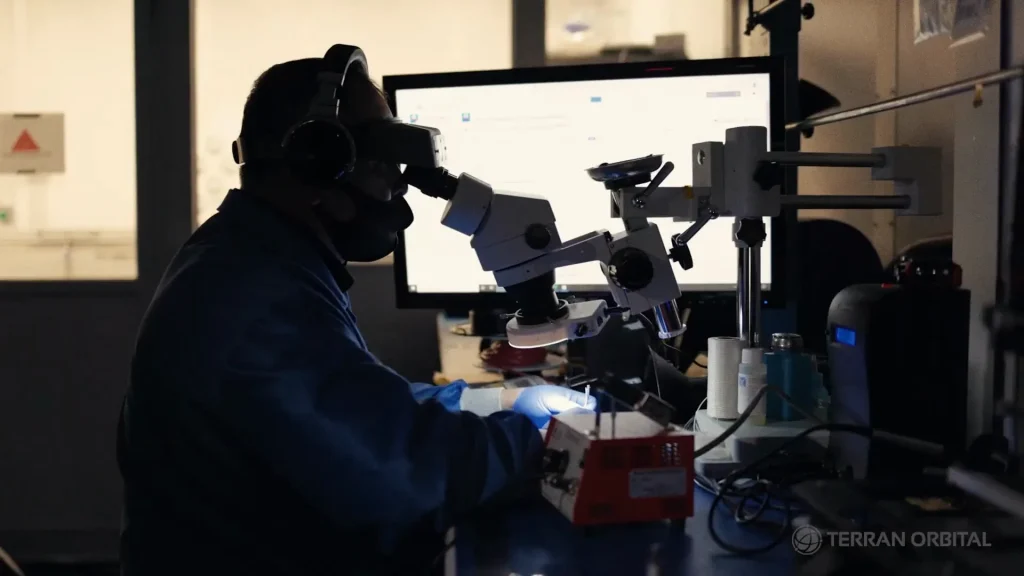 Engineer at a microscope in the clean room